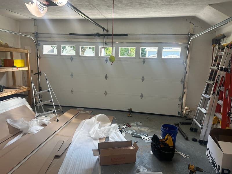 Interior view of Garaga garage door installation in progress with windows and tools